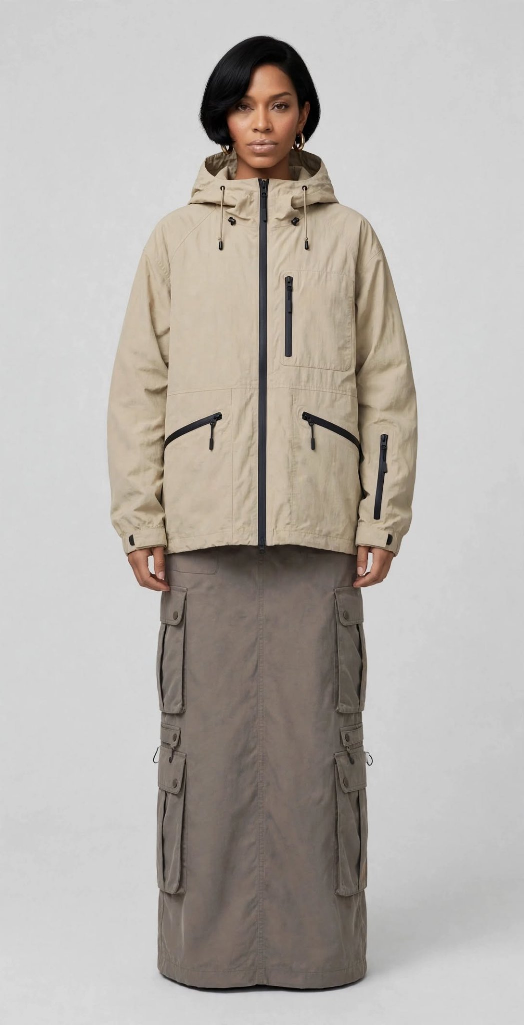 Tonal Series hero — model in a tonal beige technical hooded jacket and taupe cargo skirt, clean studio